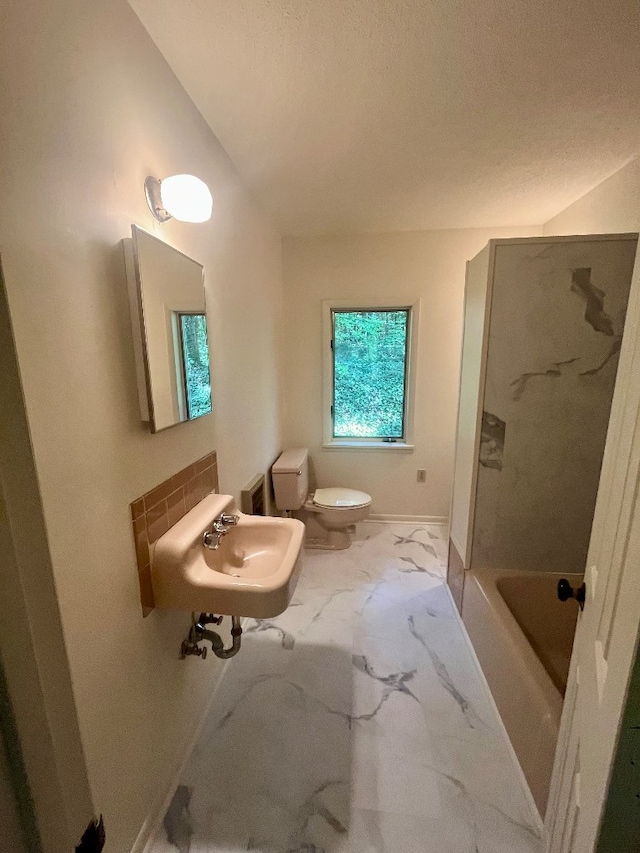 full bathroom with sink, toilet, and shower / washtub combination