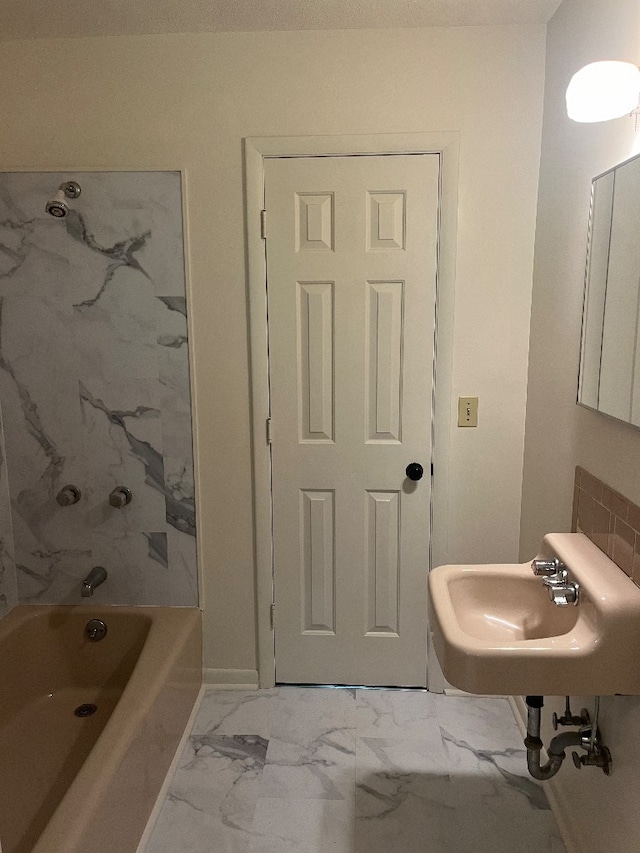 bathroom featuring shower / washtub combination and sink