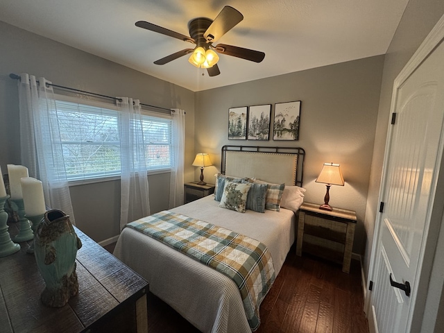 bedroom with dark wood-type flooring and ceiling fan