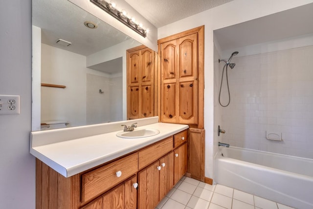 bathroom with tile patterned flooring, visible vents, tub / shower combination, vanity, and a textured ceiling