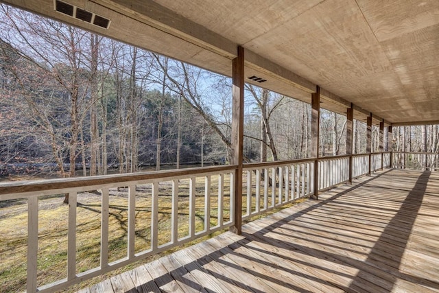 wooden terrace featuring visible vents