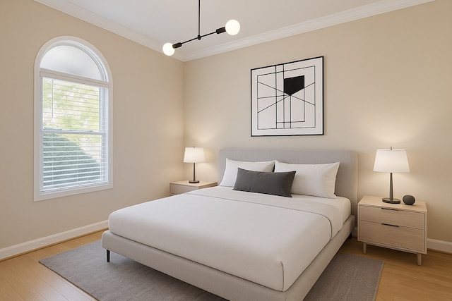 bedroom featuring ornamental molding, light wood finished floors, and baseboards