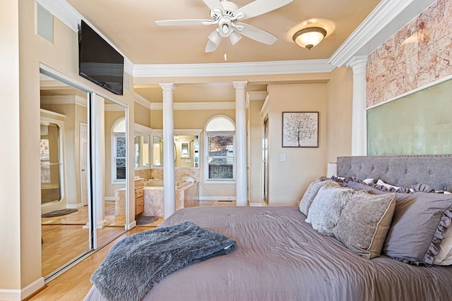 bedroom featuring crown molding, decorative columns, wood finished floors, and ceiling fan