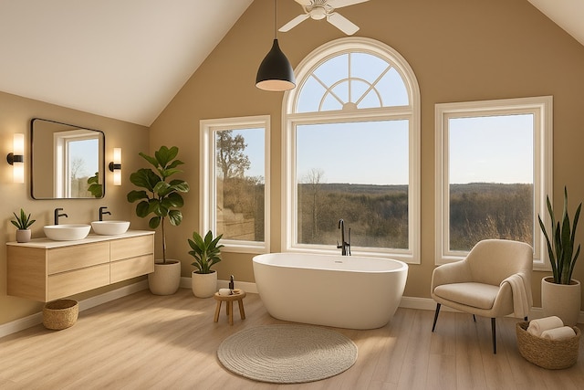 full bathroom with lofted ceiling, a ceiling fan, wood finished floors, a soaking tub, and baseboards