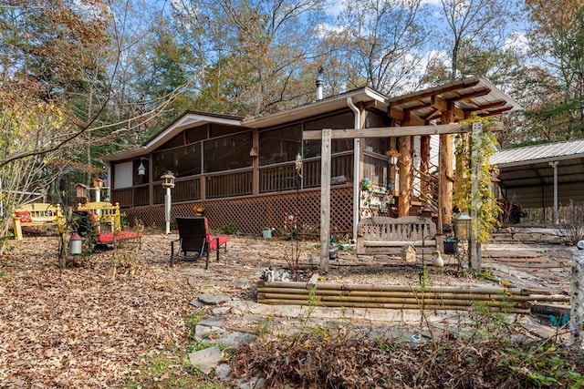 rear view of house with a sunroom and stairway