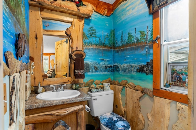 bathroom with toilet and vanity