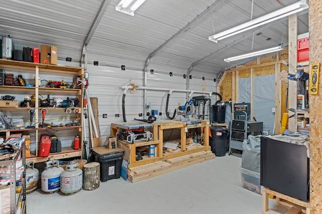 garage featuring a workshop area and metal wall