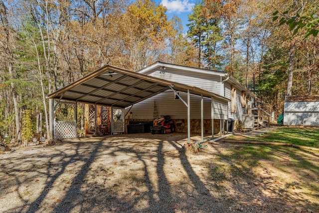 view of vehicle parking with driveway and a detached carport