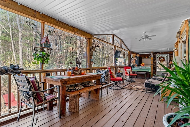 sunroom with a ceiling fan and lofted ceiling