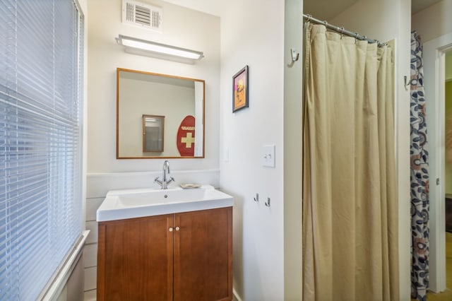 bathroom with vanity and walk in shower