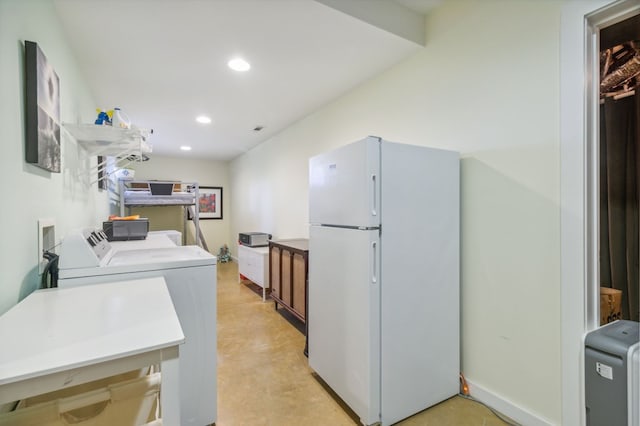 kitchen with white fridge and independent washer and dryer