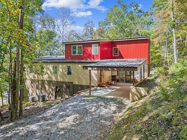 back of house with a patio area and central AC