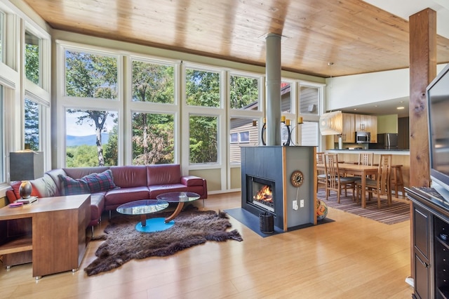 living room with plenty of natural light, wood ceiling, and light hardwood / wood-style flooring