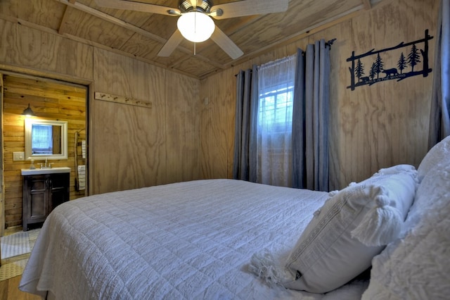 bedroom featuring ceiling fan, wood walls, and wooden ceiling