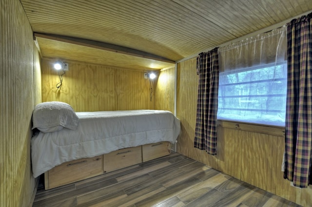 bedroom featuring wood walls and wood finished floors