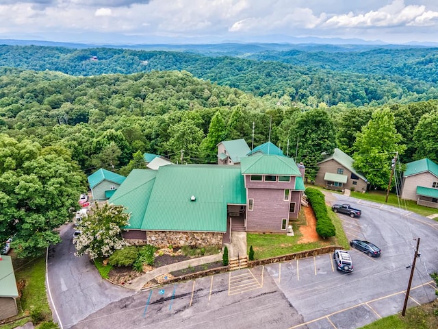 drone / aerial view with a wooded view