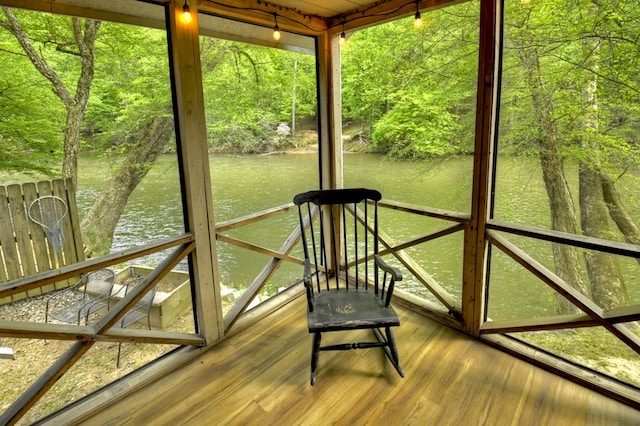 unfurnished sunroom with a water view