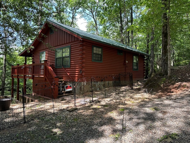 29 River Ranch Rd, Ellijay, GA 30540 - view of side of home with log siding, a wooden deck, and a metal roof