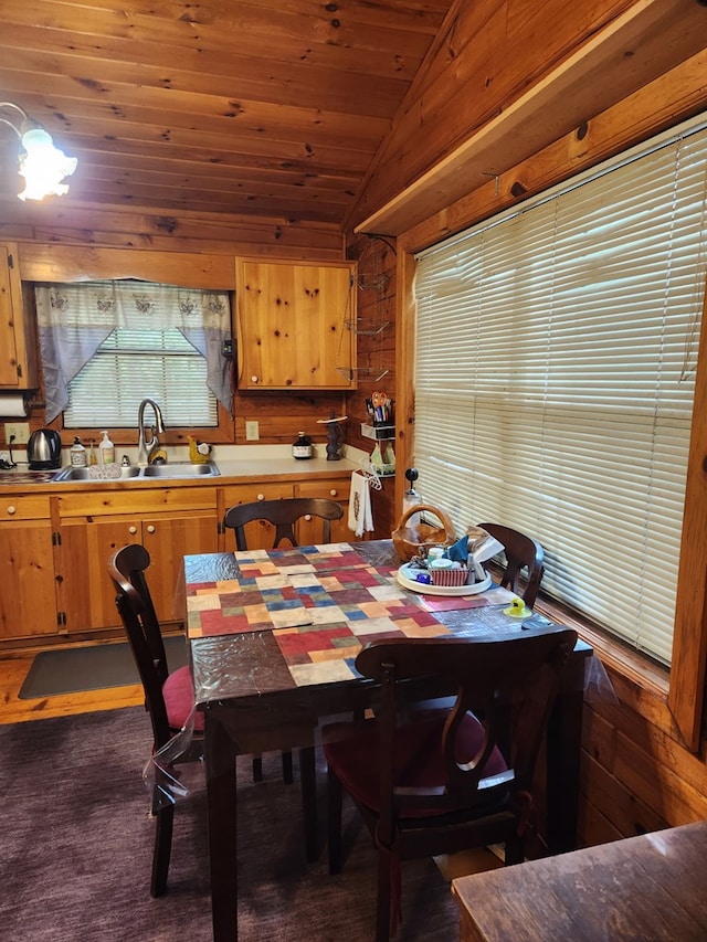 29 River Ranch Rd, Ellijay, GA 30540 - dining space featuring lofted ceiling, wood ceiling, wooden walls, and dark colored carpet