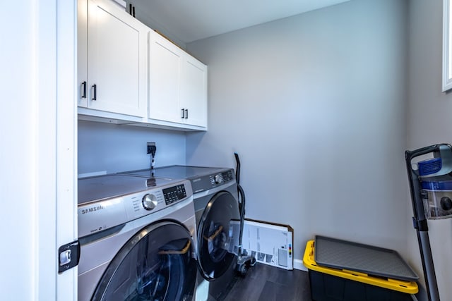 washroom with cabinet space, independent washer and dryer, and wood finished floors