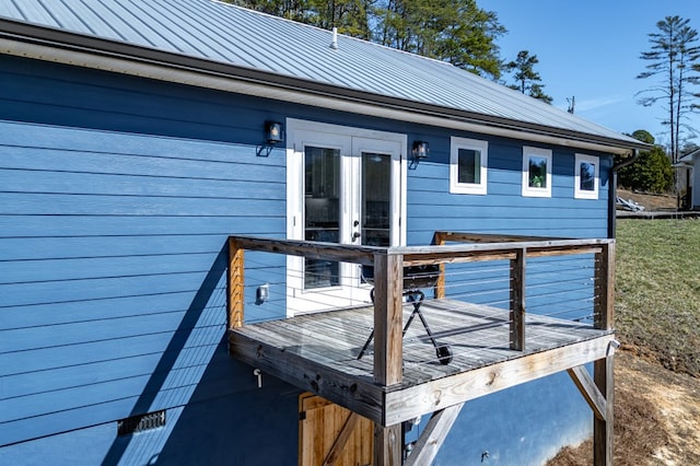 exterior space featuring metal roof, french doors, a standing seam roof, and a wooden deck