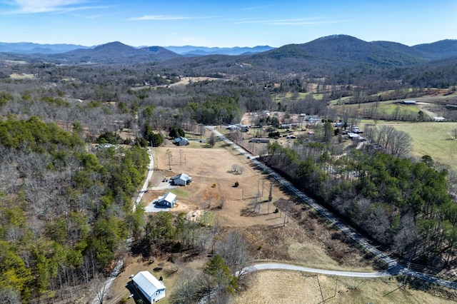 drone / aerial view featuring a mountain view and a view of trees