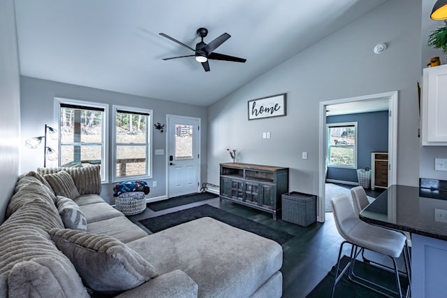 living area featuring dark wood-type flooring, vaulted ceiling, and ceiling fan