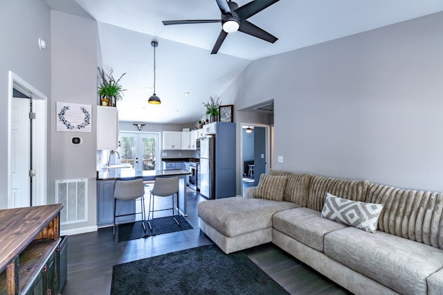 living room featuring french doors, dark wood finished floors, visible vents, ceiling fan, and high vaulted ceiling