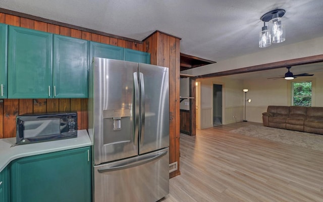 469 Hidden Valley Dr, Morganton, GA 30560 - kitchen featuring stainless steel fridge with ice dispenser, black microwave, light wood-type flooring, light countertops, and open floor plan