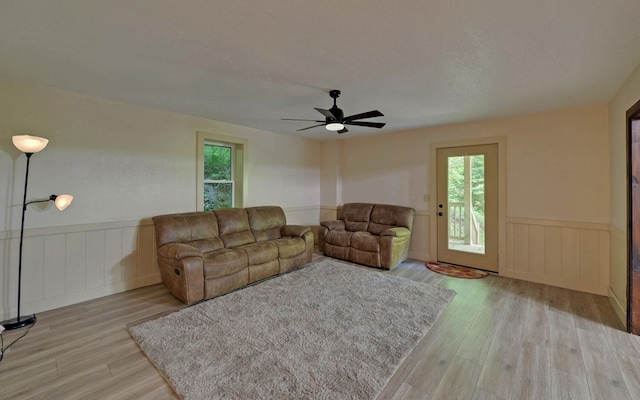 469 Hidden Valley Dr, Morganton, GA 30560 - living area featuring healthy amount of natural light, wood finished floors, a wainscoted wall, and a ceiling fan