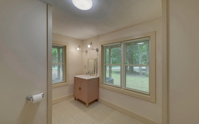 469 Hidden Valley Dr, Morganton, GA 30560 - bathroom featuring vanity, plenty of natural light, baseboards, a textured ceiling, and tile patterned flooring