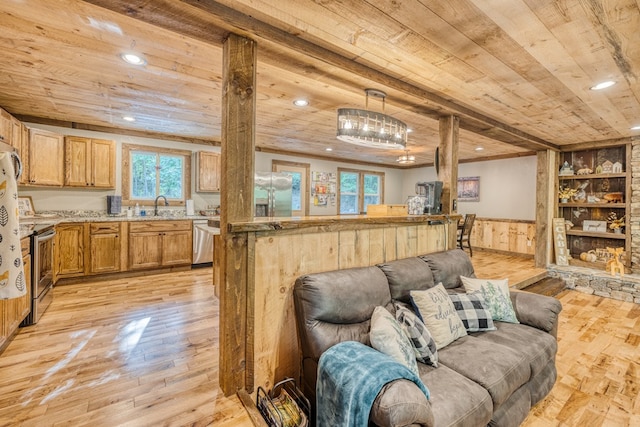 living area featuring a wainscoted wall, light wood-style flooring, and wooden ceiling