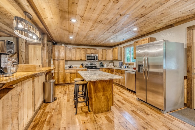 kitchen featuring wood ceiling, a kitchen bar, light wood-type flooring, recessed lighting, and appliances with stainless steel finishes