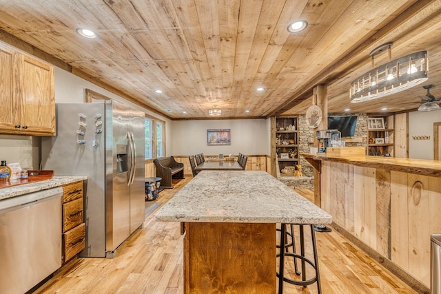 kitchen featuring a kitchen bar, recessed lighting, light wood-style flooring, appliances with stainless steel finishes, and wooden ceiling