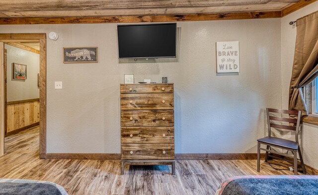 bedroom featuring baseboards and wood finished floors