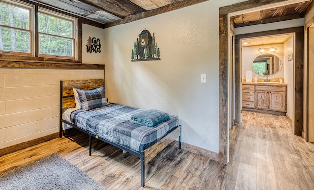 bedroom with light wood-type flooring and baseboards