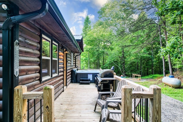 wooden deck featuring a hot tub