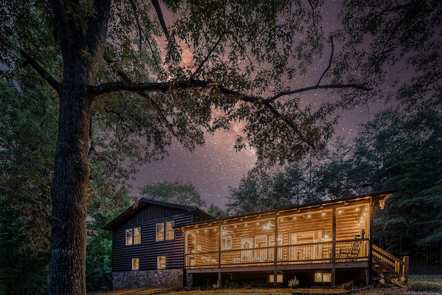 back of house with a deck and board and batten siding