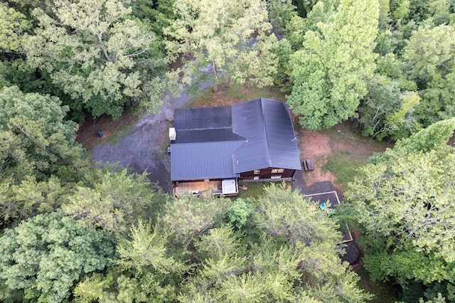 birds eye view of property featuring a view of trees