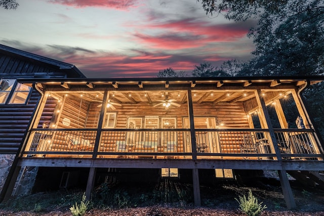 rear view of house with log veneer siding