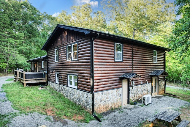 view of property exterior featuring a deck and stone siding