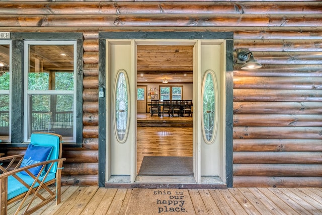 view of exterior entry with faux log siding