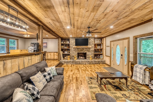 living room with wainscoting, wooden ceiling, a fireplace, and wood finished floors