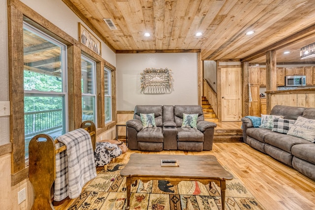 living area featuring a wainscoted wall, visible vents, light wood finished floors, recessed lighting, and wood ceiling