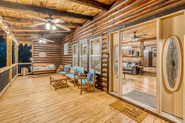 wooden terrace with outdoor lounge area and a ceiling fan