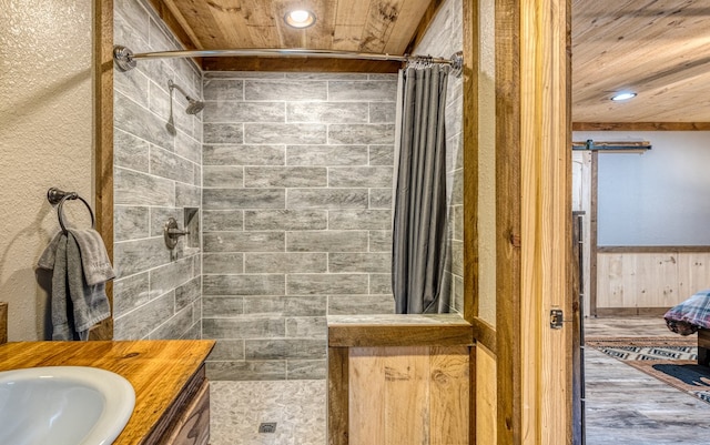 bathroom with vanity, recessed lighting, wood ceiling, and tiled shower