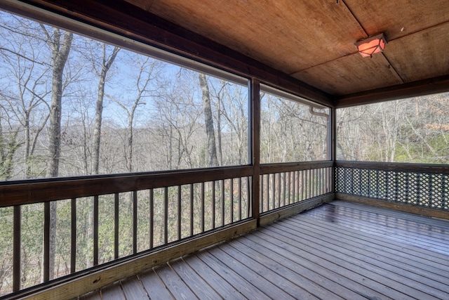 unfurnished sunroom with wooden ceiling