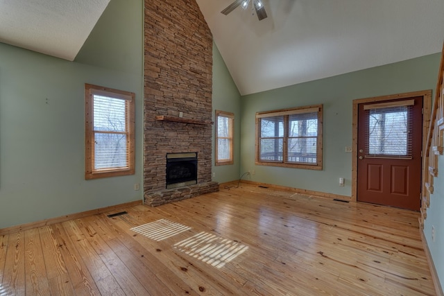 unfurnished living room with wood-type flooring, a ceiling fan, and a wealth of natural light