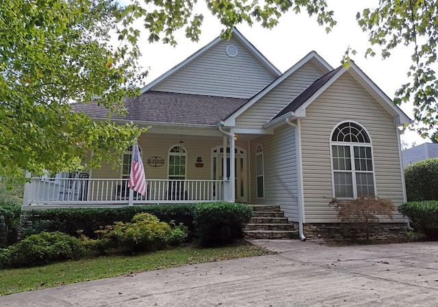 view of front of property featuring a porch and roof with shingles