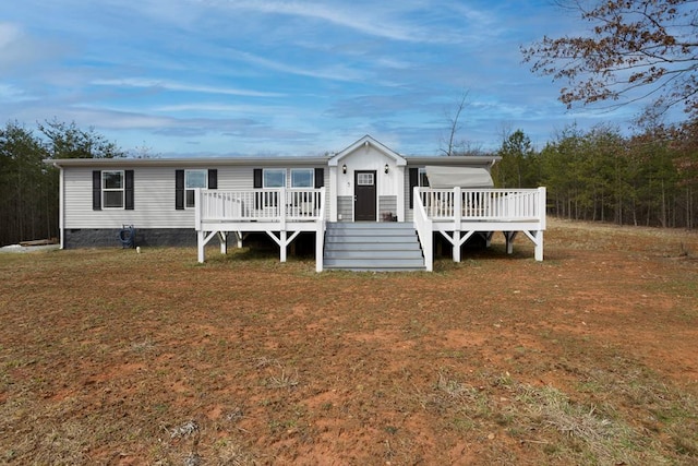 manufactured / mobile home with crawl space, a front yard, and a wooden deck